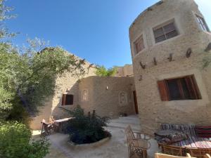 an outside view of a building with a patio at Sleep In Siwa in Siwa