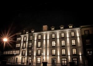 San Esteban de Pravia的住宿－Gran hotel Brillante，一座大建筑晚上点亮,灯光照亮