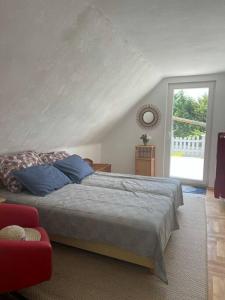 a bedroom with a large bed and a window at Verandás Vendégház in Balatonkenese