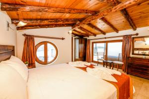 a bedroom with a large bed and a mirror at Carla Apart Kalkan in Kalkan +24 photos