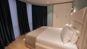 Postel nebo postele na pokoji v ubytování Granda Hotel