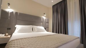 Postel nebo postele na pokoji v ubytování Granda Hotel