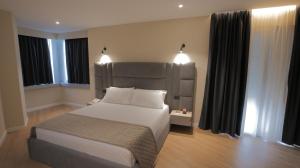 Postel nebo postele na pokoji v ubytování Granda Hotel