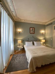 1 dormitorio con 1 cama grande con sábanas blancas en Mercador, en Lisboa