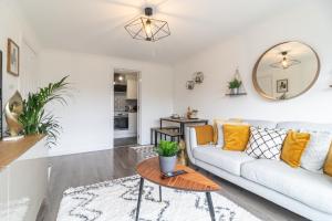 a living room with a couch and a table at Luxury Glasgow Flat in the heart of the Westend in Glasgow