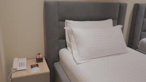 Postel nebo postele na pokoji v ubytování Granda Hotel