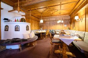 a dining room with tables and chairs and wooden walls at Montfort in Lech am Arlberg