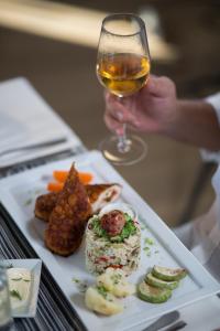 a plate of food and a glass of wine at Spa Resort Luxury Apartments in Budva