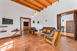 a living room with a couch and chairs and a table at Petit La Geria Lanzarote in Tías