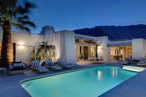a swimming pool in front of a house at Plush Pad Palm Springs Permit# 2937 in Palm Springs