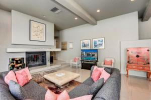 a living room with a couch and a fireplace at Plush Pad Palm Springs Permit# 2937 in Palm Springs