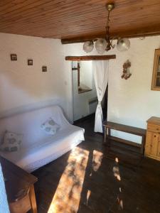 a bedroom with a bed and a chandelier at En pleine nature avec jardin in Les Blancs
