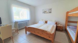 a bedroom with a bed and a bunk bed at Gästehaus Reinke - nahe Europa-Park in Ettenheim