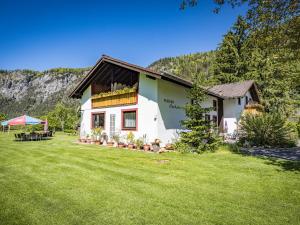 a house with a green lawn in front of it at Hotel- Pension Oechsner in Bad Reichenhall