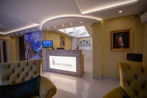 a waiting room with two chairs and a large screen at Silver Tower Family Apart Otel in Kuşadası