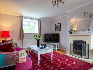 a living room with a couch and a fireplace at Swallows Rest in Broadway