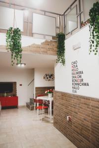 a room with a table and a brick wall at Frizzi & Lazzi House in Naples