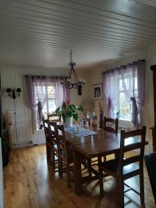 a dining room with a wooden table and chairs at Egil's Vacation House in Lillehammer