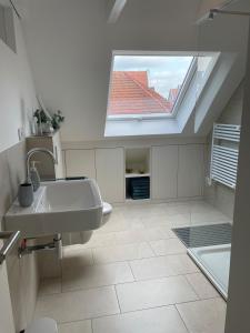 a bathroom with a sink and a skylight at Loft Sternenblick in Lüdinghausen