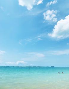 two people swimming in the ocean on a beach at Casa de praia em Barra do Gil in Vera Cruz de Itaparica