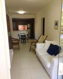 a living room with a white couch and a table at Charming Guarajuba in Guarajuba +17 photos
