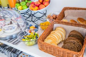 two baskets of bread and fruit on a table at Hotel Gabbiano in Rimini