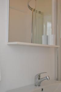 a bathroom sink with a mirror and a bathroom sink at Tsartsada house in Áno Lefkímmi