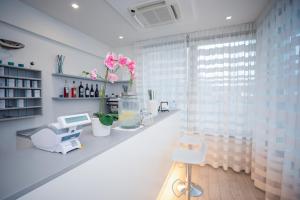 a room with a counter with flowers and a window at Hotel Gabbiano in Rimini