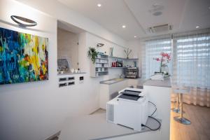 a white room with a painting on the wall at Hotel Gabbiano in Rimini