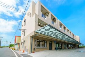 a building with a large balcony on the side of it at Rice mansion in Wujie