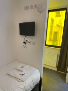 
a television and a bed in a room at ART B&B in Blackpool
