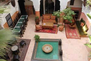 an overhead view of a patio with a couch and chairs at Riad Jnan El Cadi in Marrakech