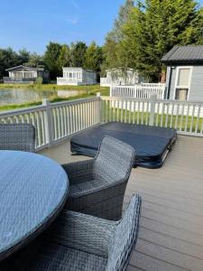 a patio with a table and chairs and a mattress at Bramble Lodge with Hot Tub in York