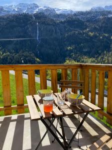 a picnic table on a deck with a view at Le Nid in Vaujany