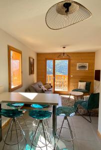a living room with a table and chairs at Le Nid in Vaujany