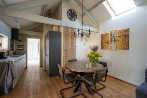 a kitchen and dining room with a table and chairs at TUUS in Dishoek in Dishoek