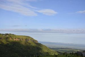 a view of a green hill with trees on it at Sipi Valley Resort in Mbale