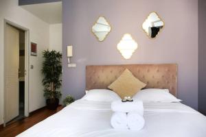 a bedroom with a white bed with two towels at 404 - Petit bijou dans immeuble hôtelier Paris 5 in Paris