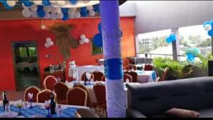 a dining room with tables and chairs and blue balloons at RÉSIDENCE VICTORIA in Lomé