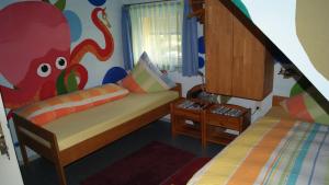 a room with two beds and a childs bedroom at Pension Weinsberg in Weinsberg