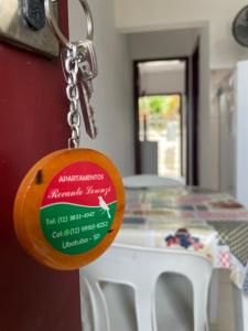 a key chain is attached to a table at Recanto Lorenzi - Apartamentos in Ubatuba