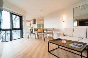 a living room with a couch and a table at Westcliff Penthouse in Bournemouth