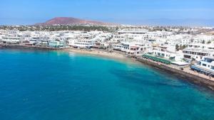 an aerial view of a beach with white buildings at Blancazul La Rociega in Playa Blanca