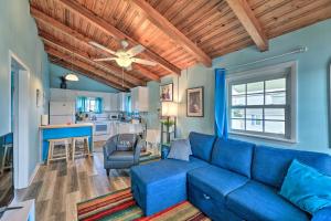 a living room with a blue couch and a kitchen at Pet-Friendly Townhome, 2 Blocks to Atlantic Beach! in Atlantic Beach