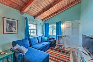 a blue living room with a blue couch and a tv at Pet-Friendly Townhome, 2 Blocks to Atlantic Beach! in Atlantic Beach