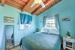 a blue bedroom with a bed and a window at Pet-Friendly Townhome, 2 Blocks to Atlantic Beach! in Atlantic Beach
