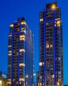 two tall buildings in a city at night at Global Luxury Suites at The Arches in Bronx