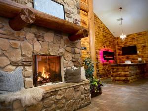 a fireplace in a room with a stone wall at Balsam Lake Lodge in Balsam Lake