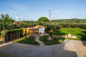 a backyard with a tent and a garden at Cozy flats in an olive grove by the sandy beach in Kánalos