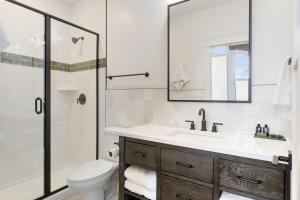 a bathroom with a toilet and a sink and a shower at Balsam Lake Lodge in Balsam Lake